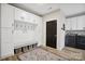 Well-lit laundry room boasts wooden floors, cabinets, seating, and modern appliances for convenience at 324 Patternote Rd, Mooresville, NC 28117