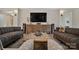 Cozy living room featuring neutral tones, a large wooden coffee table, and stylish lighting fixtures at 324 Patternote Rd, Mooresville, NC 28117