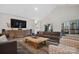 Comfortable living room boasts vaulted ceilings, a large TV, and stylish, modern furnishings at 324 Patternote Rd, Mooresville, NC 28117