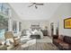 A bright primary bedroom with high ceilings, a seating area, and a calming color palette at 324 Patternote Rd, Mooresville, NC 28117