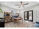 Bright home office featuring double doors to patio, ceiling fan, and built-in shelving at 324 Patternote Rd, Mooresville, NC 28117