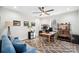 Bright home office featuring a ceiling fan, stylish rug, and wooden desk and shelving at 324 Patternote Rd, Mooresville, NC 28117
