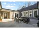 Spacious outdoor patio featuring a fire pit, comfortable seating, and string lights at 324 Patternote Rd, Mooresville, NC 28117