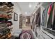 Large walk-in closet with custom shelving, ample shoe storage, and a decorative area rug at 324 Patternote Rd, Mooresville, NC 28117