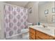 Bright bathroom with white fixtures and a decorative shower curtain, offering a clean, inviting space at 3247 Bamburgh Ct, Charlotte, NC 28216