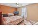 Inviting bedroom with warm tones, features a TV, ceiling fan and a large window for natural light at 3247 Bamburgh Ct, Charlotte, NC 28216