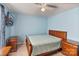 Comfortable blue bedroom with a ceiling fan, mounted TV, and matching furniture at 3247 Bamburgh Ct, Charlotte, NC 28216