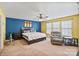 Large bedroom featuring a ceiling fan, warm-toned walls, and relaxing reading chair by bright windows at 3247 Bamburgh Ct, Charlotte, NC 28216