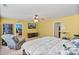 Well-lit bedroom showing furniture, ceiling fan, and doorway to a separate room at 3247 Bamburgh Ct, Charlotte, NC 28216