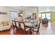 Formal dining room featuring a glass-top table, elegant chairs, and hardwood floors at 3247 Bamburgh Ct, Charlotte, NC 28216