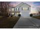 Charming two-story home with blue shutters, attached two-car garage, and well-manicured front lawn at 3247 Bamburgh Ct, Charlotte, NC 28216