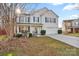 Inviting two-story home with blue shutters, a covered porch, a two-car garage, and a well-maintained lawn at 3247 Bamburgh Ct, Charlotte, NC 28216