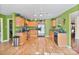 Spacious kitchen with stainless steel appliances, granite countertops, and natural wood flooring at 3247 Bamburgh Ct, Charlotte, NC 28216