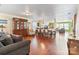 Open concept living room and dining room with hardwood floors, natural light, and stylish furnishings at 3247 Bamburgh Ct, Charlotte, NC 28216