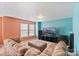 Bright living room boasts neutral carpet, a large sectional, and media center for relaxed entertaining at 3247 Bamburgh Ct, Charlotte, NC 28216