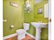 Updated half bathroom with a pedestal sink and neutral color scheme at 3247 Bamburgh Ct, Charlotte, NC 28216