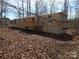 Charming mobile home nestled in a wooded area, featuring a wooden deck at 335 Lake Landing Dr, Salisbury, NC 28146