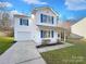 Charming two-story home with blue shutters and a cozy front porch, perfect for enjoying quiet evenings at 4070 Shasta Cir, Clover, SC 29710