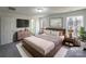 Stylishly staged main bedroom features a comfortable bed, modern decor, and ample natural light at 4070 Shasta Cir, Clover, SC 29710