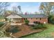 A beautiful brick home with a covered patio and backyard space at 410 Deerwood Dr, Gastonia, NC 28054