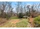 A large backyard featuring a storage shed and wood stairs leading down from the home at 410 Deerwood Dr, Gastonia, NC 28054