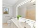 Bathroom featuring lighted mirror, vanity and toilet with shower in the background at 410 Deerwood Dr, Gastonia, NC 28054