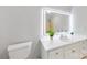 Clean bathroom featuring modern mirror, vanity and toilet with shower in the background at 410 Deerwood Dr, Gastonia, NC 28054