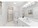 Well-lit bathroom with a glass door shower, and a large vanity mirror at 410 Deerwood Dr, Gastonia, NC 28054