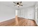 Spacious bedroom featuring hardwood floors, a ceiling fan and two double door closets at 410 Deerwood Dr, Gastonia, NC 28054