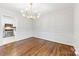 Elegant dining room with decorative moldings and a modern chandelier, adjacent to the kitchen at 410 Deerwood Dr, Gastonia, NC 28054