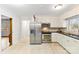 Charming kitchen with white cabinetry, stainless steel appliances and tile floor at 410 Deerwood Dr, Gastonia, NC 28054
