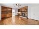 Cozy living room with brick fireplace, built-in shelving, and hardwood floors at 410 Deerwood Dr, Gastonia, NC 28054