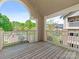 Outdoor balcony with views of the community's grounds and neighborhood, and featuring wooden flooring and white railings at 5011 Sharon Rd # J, Charlotte, NC 28210