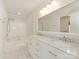 Spacious bathroom featuring double sinks, marble countertops, updated fixtures, and a soaking tub with shower at 5011 Sharon Rd # J, Charlotte, NC 28210