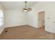 Spacious bedroom featuring neutral carpeting, a ceiling fan, and ample natural light at 5011 Sharon Rd # J, Charlotte, NC 28210