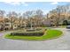 This roundabout is beautifully landscaped and features a brick fountain at 5011 Sharon Rd # J, Charlotte, NC 28210