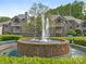 Residential building featuring manicured landscaping and a lovely brick fountain at 5011 Sharon Rd # J, Charlotte, NC 28210