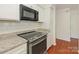 Updated kitchen showcasing stainless steel appliances, granite countertops, and white cabinetry at 5011 Sharon Rd # J, Charlotte, NC 28210