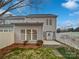 Back exterior featuring a well-kept yard, patio, and neutral colored siding at 5084 Parkview Way, Matthews, NC 28104