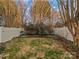 Fenced backyard featuring a well-maintained lawn, decorative trees, and mature shrubs at 5084 Parkview Way, Matthews, NC 28104