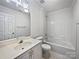 Clean bathroom with white vanity, bathtub and shower combination, and tile flooring at 5084 Parkview Way, Matthews, NC 28104