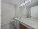 Bright bathroom featuring a large mirror, white vanity, and marble-style flooring at 5084 Parkview Way, Matthews, NC 28104