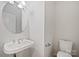 Modern half bathroom showcasing a pedestal sink, chrome fixtures, and a clean, minimalist design at 5084 Parkview Way, Matthews, NC 28104