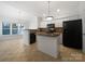 Bright kitchen with white cabinetry, black appliances, tile floors, and breakfast nook at 5084 Parkview Way, Matthews, NC 28104