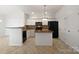 Well-lit kitchen featuring stainless steel appliances, central island, breakfast bar, and tile flooring at 5084 Parkview Way, Matthews, NC 28104