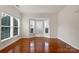 Bright living room boasting hardwood floors, elegant molding, and large windows with natural light at 5084 Parkview Way, Matthews, NC 28104