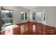 Spacious living room featuring hardwood floors, many windows, and natural light at 5084 Parkview Way, Matthews, NC 28104