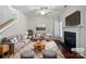 Bright living room with fireplace, hardwood floors, stylish furniture, and a ceiling fan at 5084 Parkview Way, Matthews, NC 28104