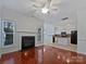 Cozy living room featuring a fireplace, ceiling fan, wood floors, and an open floor plan at 5084 Parkview Way, Matthews, NC 28104