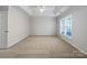 Spacious bedroom featuring a tray ceiling and a large window, ready for personalized design at 5084 Parkview Way, Matthews, NC 28104